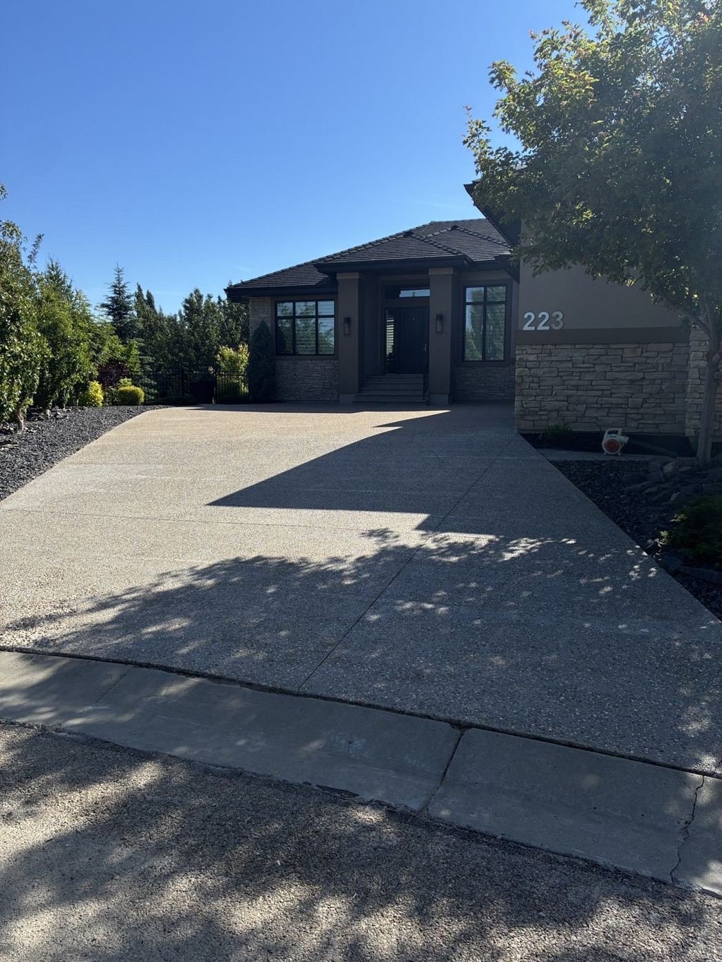 Freshly sealed exposed aggregate driveway in Edmonton