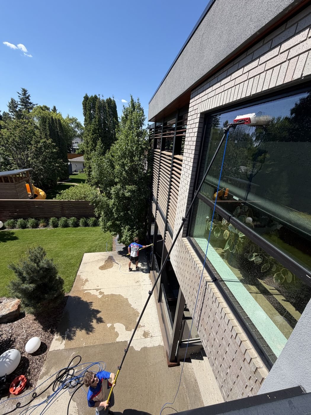 Rooftop view of window cleaning in progress